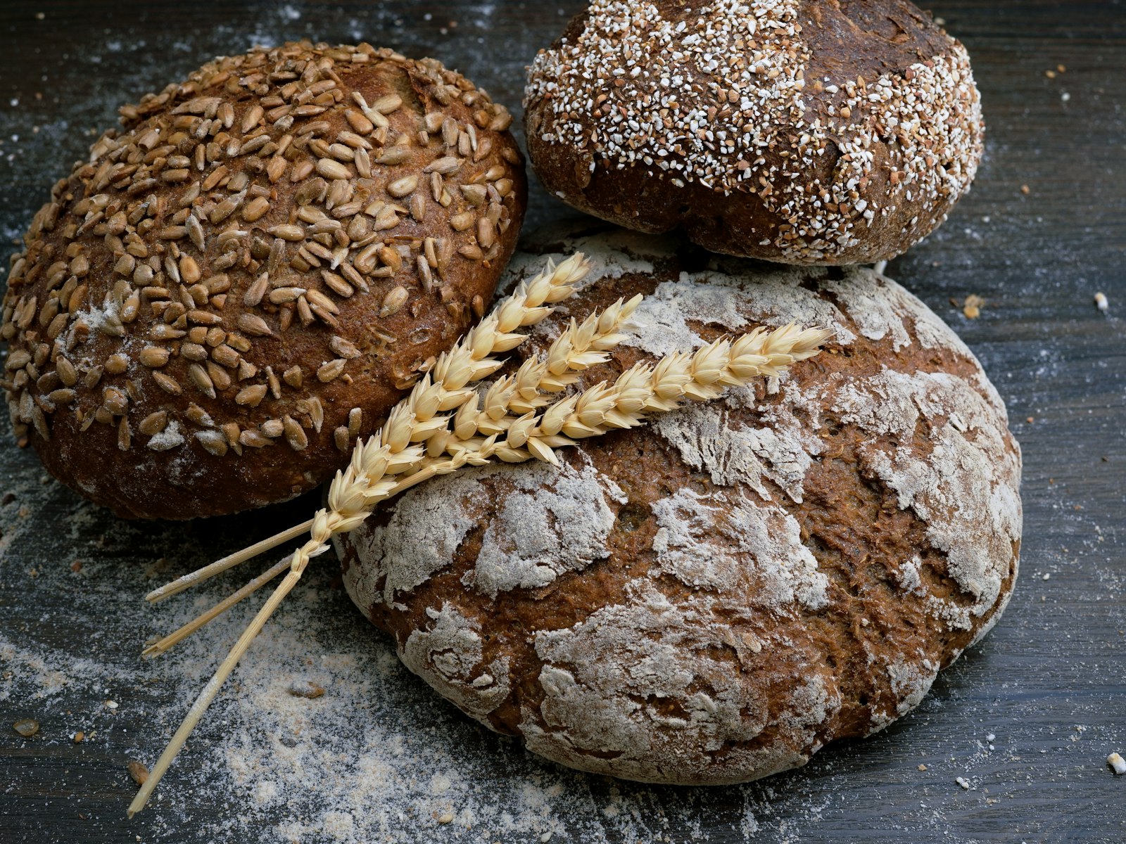 Round rye loaves with a few stalks of wheat