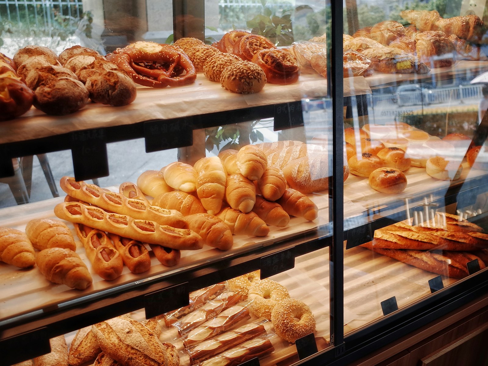 A glass case full of breads and pastries